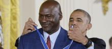 Michael Jordan ’86 gets an assist from President Barack Obama in putting on the Presidential Medal of Freedom at the White House ceremony on Nov. 22. (Photo by Sipa USA via AP)